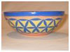 A Bali stoneware small bowl, decorated with blue geomatric design on yellow background  - first view.